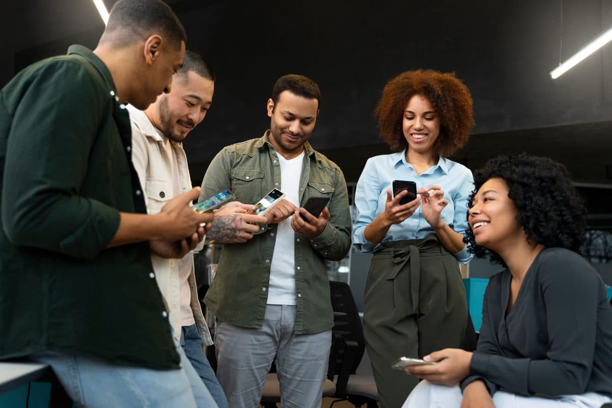 A team of business owners connecting over their phones